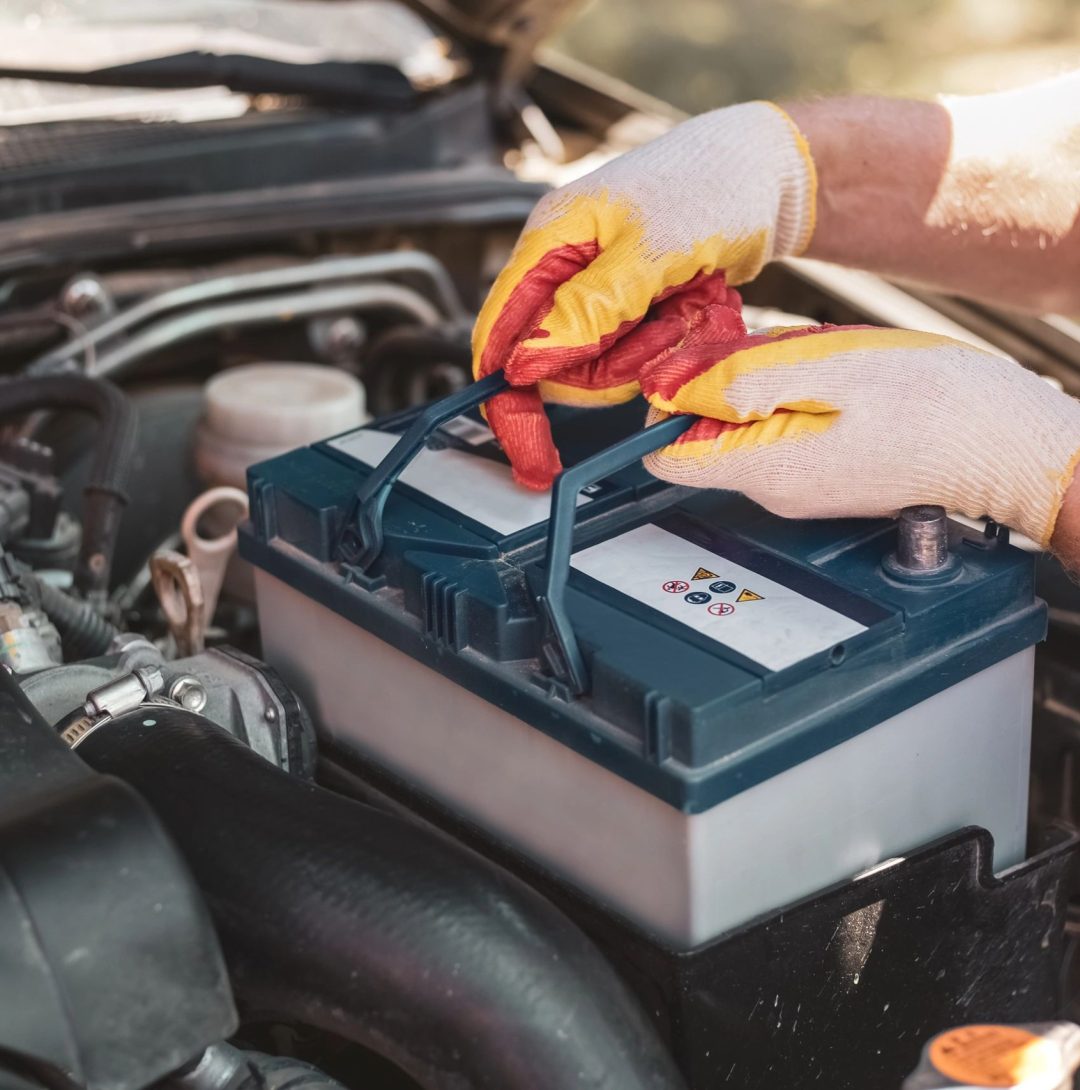 technician replacing car battery